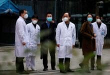 Chinese medical workers are seen as members of the World Health Organisation (WHO) team tasked with investigating the origins of the coronavirus disease (COVID-19) leave Hubei Provincial Hospital of Integrated Chinese and Western Medicine in Wuhan, Hubei province, China January 29, 2021. REUTERS/Thomas Peter