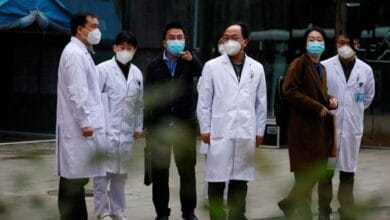 Chinese medical workers are seen as members of the World Health Organisation (WHO) team tasked with investigating the origins of the coronavirus disease (COVID-19) leave Hubei Provincial Hospital of Integrated Chinese and Western Medicine in Wuhan, Hubei province, China January 29, 2021. REUTERS/Thomas Peter