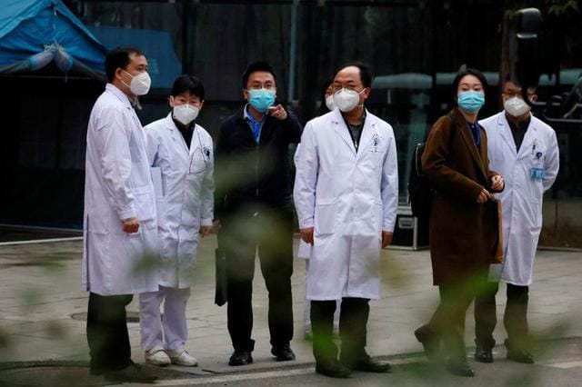 Chinese medical workers are seen as members of the World Health Organisation (WHO) team tasked with investigating the origins of the coronavirus disease (COVID-19) leave Hubei Provincial Hospital of Integrated Chinese and Western Medicine in Wuhan, Hubei province, China January 29, 2021. REUTERS/Thomas Peter