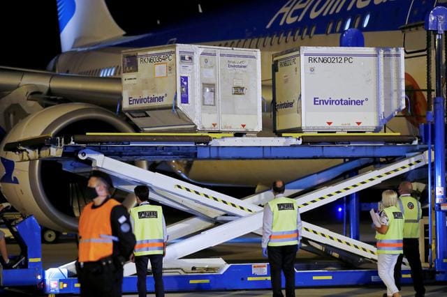 A shipment of 900,000 doses of Sinovac coronavirus disease (COVID-19) vaccine is unloaded from an aircraft after arriving from China at Ezeiza International Airport, in Buenos Aires, Argentina, February 25, 2021. REUTERS/Agustin Marcarian