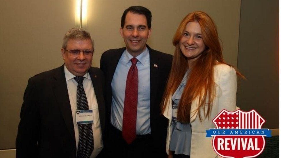 image captionMaria Butina travelled to NRA conventions in the US and is seen here with Alexander Torshin (L) and Wisconsin Governor Scott Walker