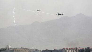 Anti-missile decoy flares are deployed as U.S. Black Hawk military helicopters fly over the city of Kabul, Afghanistan, Sunday, Aug. 15, 2021. Taliban fighters entered the outskirts of the Afghan capital on Sunday and said they were awaiting a “peaceful transfer” of the city after promising not to take it by force, but amid the uncertainty panicked workers fled government offices and helicopters landed at the U.S. Embassy. (AP Photo/Rahmat Gul)