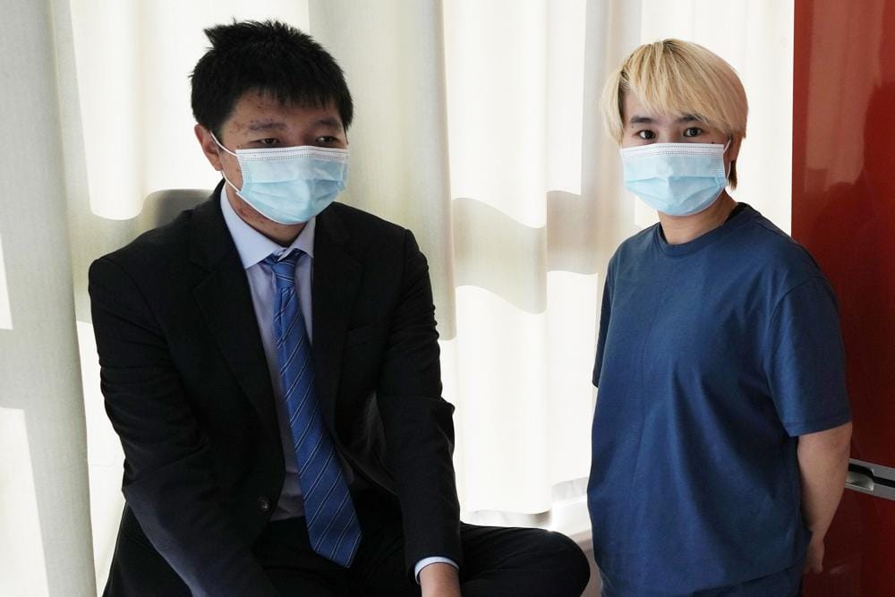Wu Huan, right, and Wang Jingyu stand together in a safe house in the Ukraine on Wednesday, June 30, 2021. Wu claims that she was held for eight days at a Chinese-run “black site” in Dubai along with at least two Uyghurs, in what may be the first evidence that China is operating a secret detention facility beyond its borders. She was on the run from the threat of being sent back to her home country because of her support of her fiance, Wang, a perceived Chinese dissident. (AP Photo)
