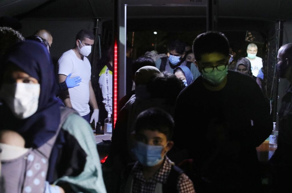 People who have been evacuated from Afghanistan arrive at Tirana International Airport, after Taliban insurgents entered Afghanistan's capital Kabul, in Tirana, Albania, August 27, 2021. REUTERS/Florion Goga