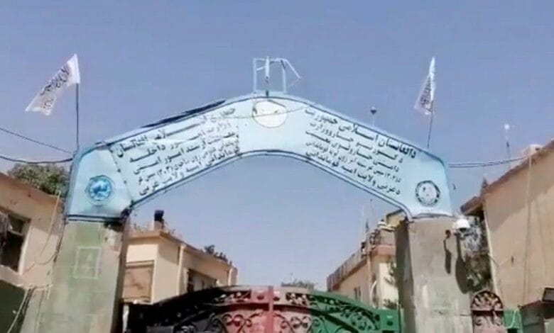 A view shows Taliban flags raised at the gates outside the police headquarters, in city of Ghazni, Afghanistan in this screen grab taken from a video released by the Taliban on August 12, 2021. Taliban Handout/via REUTERS
