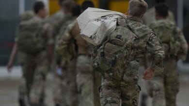 Members of the British armed forces 16 Air Assault Brigade walk to the air terminal after disembarking a RAF Voyager aircraft at Brize Norton, England, as they return from helping in operations to evacuate people from Kabul airport in Afghanistan, Saturday, Aug. 28, 2021. More than 100,000 people have been safely evacuated through the Kabul airport, according to the U.S., but thousands more are struggling to leave in one of history's biggest airlifts. (AP Photo/Alastair Grant, Pool)