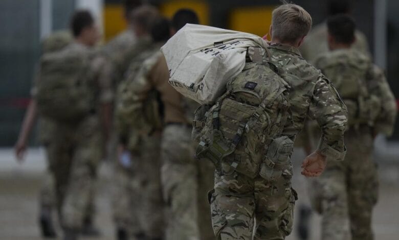Members of the British armed forces 16 Air Assault Brigade walk to the air terminal after disembarking a RAF Voyager aircraft at Brize Norton, England, as they return from helping in operations to evacuate people from Kabul airport in Afghanistan, Saturday, Aug. 28, 2021. More than 100,000 people have been safely evacuated through the Kabul airport, according to the U.S., but thousands more are struggling to leave in one of history's biggest airlifts. (AP Photo/Alastair Grant, Pool)