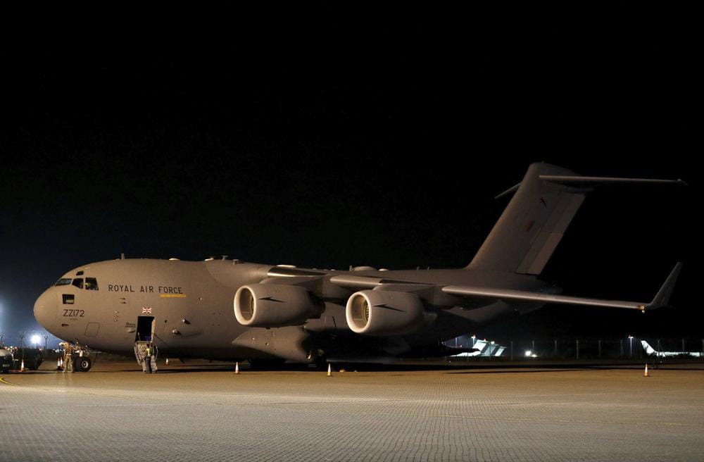 British military personnel depart a C-17 aircraft at Royal Air Force Brize Norton, Oxfordshire, late Sunday, Aug. 29, 2021. The final UK troops and diplomatic staff were airlifted from Kabul on Saturday, drawing to a close Britain's 20-year engagement in Afghanistan and a two-week operation to rescue UK nationals and Afghan allies. (Peter Nicholls/Pool Photo via AP)