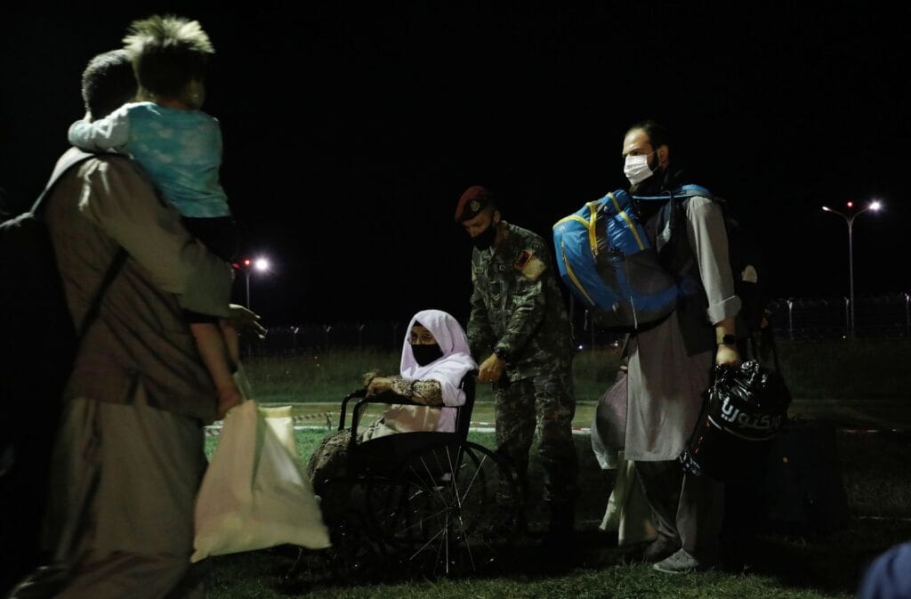 People who have been evacuated from Afghanistan arrive at Tirana International Airport, after Taliban insurgents entered Afghanistan's capital Kabul, in Tirana, Albania, August 27, 2021. REUTERS/Florion Goga