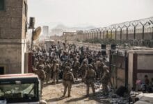 In this Aug. 21, 2021, photo provided by the U.S. Marines, U.S. Marines with Special Purpose Marine Air-Ground Task Force - Crisis Response - Central Command, provide assistance at an evacuation control checkpoint during an evacuation at Hamid Karzai International Airport in Kabul, Afghanistan. (Staff Sgt. Victor Mancilla/U.S. Marine Corps via AP)