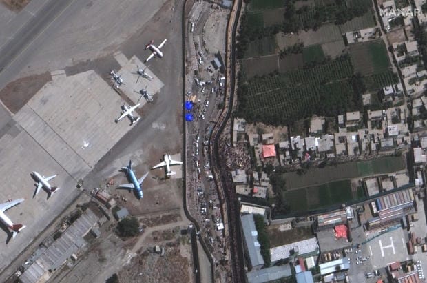 A satellite photo shows crowds of people outside Abbey Gate at the airport in Kabul, Afghanistan, on August 24, 2021. Satellite image ©2021 Maxar Technologies