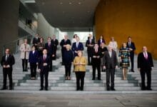 Acting German Chancellor Angela Merkel poses with her government after the weekly cabinet meeting at the Chancellery in Berlin, Germany, November 24, 2021. Markus Schreiber/Pool via REUTERS