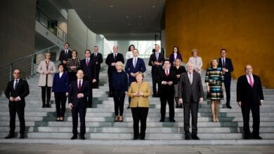 Acting German Chancellor Angela Merkel poses with her government after the weekly cabinet meeting at the Chancellery in Berlin, Germany, November 24, 2021. Markus Schreiber/Pool via REUTERS