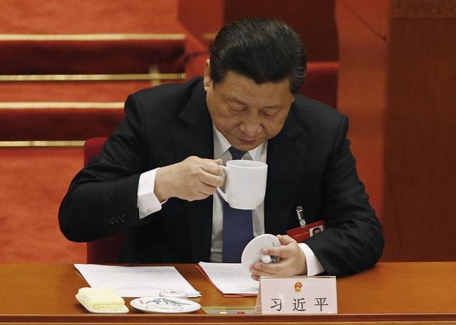 China's President Xi Jinping drinks from a cup during the closing ceremony of the Chinese National People's Congress (NPC) at the Great Hall of the People, in Beijing, March 13, 2014. REUTERS/Kim Kyung-Hoon/Files