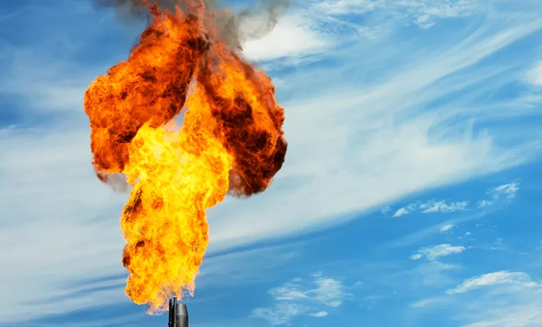 Gas flaring. Torch against the sky.