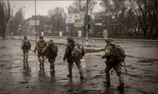 Ukrainian troops move through the streets of Bakhmut, eastern Ukraine, as fighting against Russian forces there rages and casualties mount. Photograph: Chris McGrath/Getty Images
